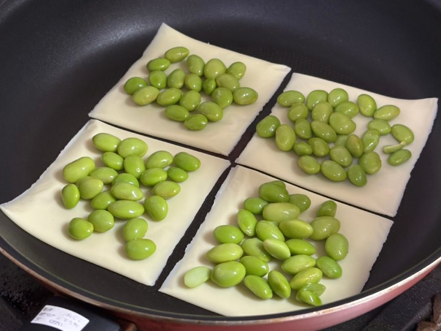フライパンにスライスチーズを並べ、その上に枝豆を散らす