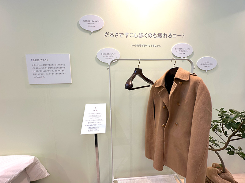 重りのついたコートで、生理による身体の重さを表す展示