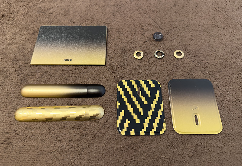 上段左から　「IQOS ILUMA i PRIME セレッティ ラップカバー」「IQOS ILUMA i PRIME / ILUMA i セレッティ リングセット」、下段左から「IQOS ILUMA i セレッティ ドアカバー」、「IQOS ILUMA i ONE セレッティ グリップバッチ」